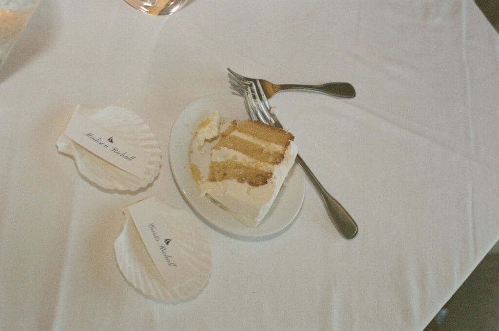 reception details captured on film showing cake with soft, dreamy tones