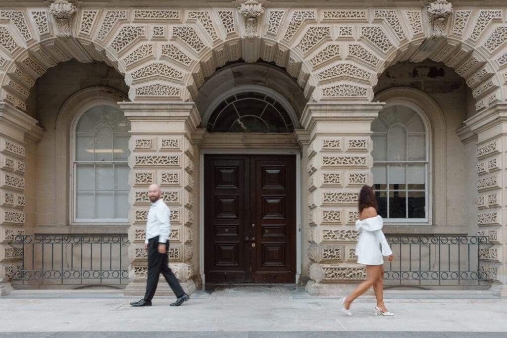 Romantic engagement portrait of Cheyanne and Keegan walking through Osgoode Hall in Toronto