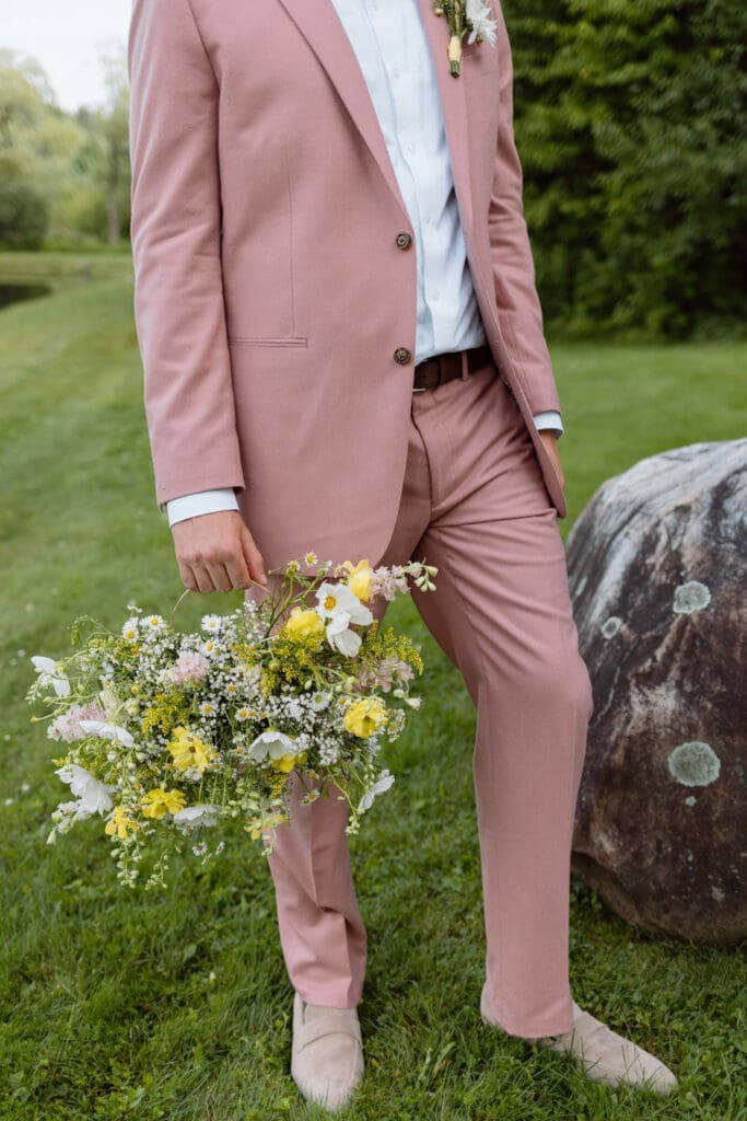 Groom wearing a pink suit before the ceremony
