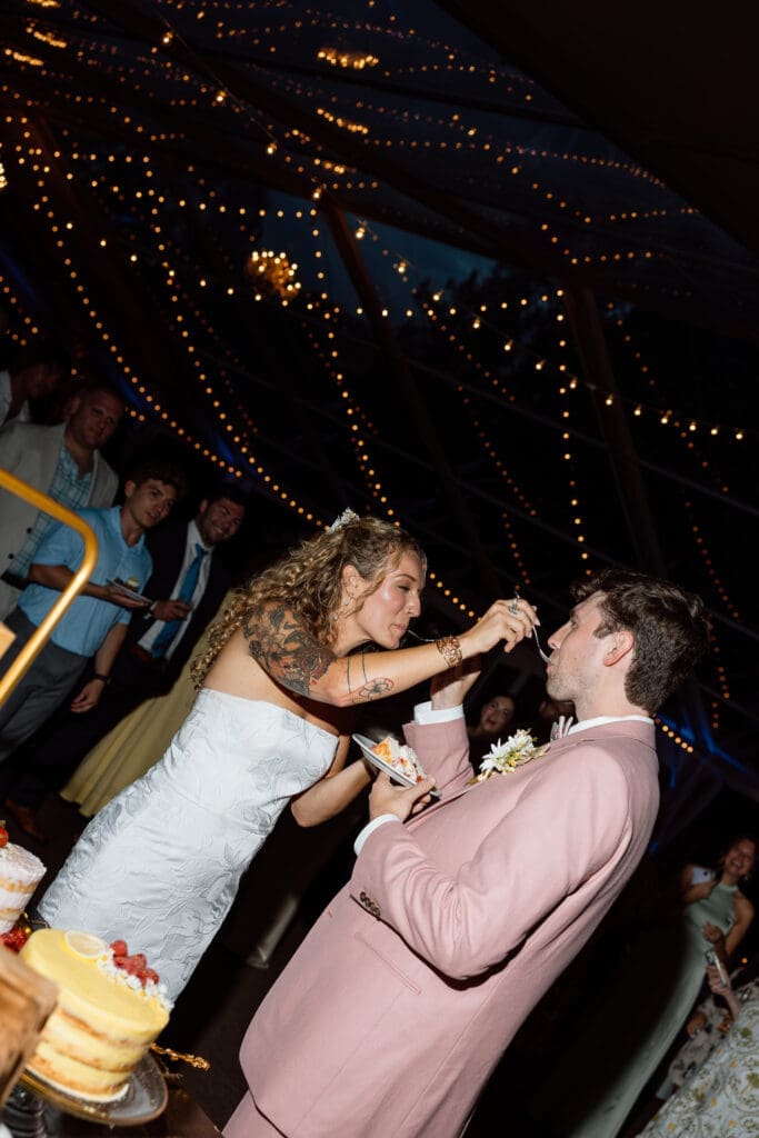 Bride and groom cutting their wedding cake during the reception
