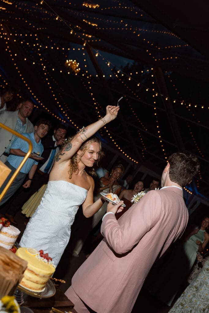 Bride and groom cutting their wedding cake during the reception
