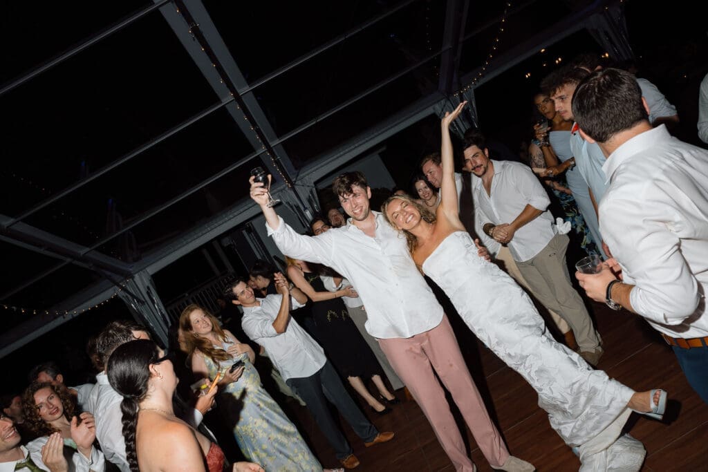 Bride and groom dancing with guests during the wedding reception
