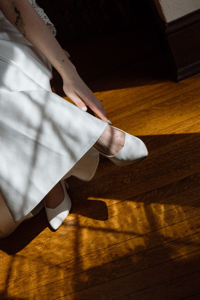 Bride getting ready in natural window light at Parque
