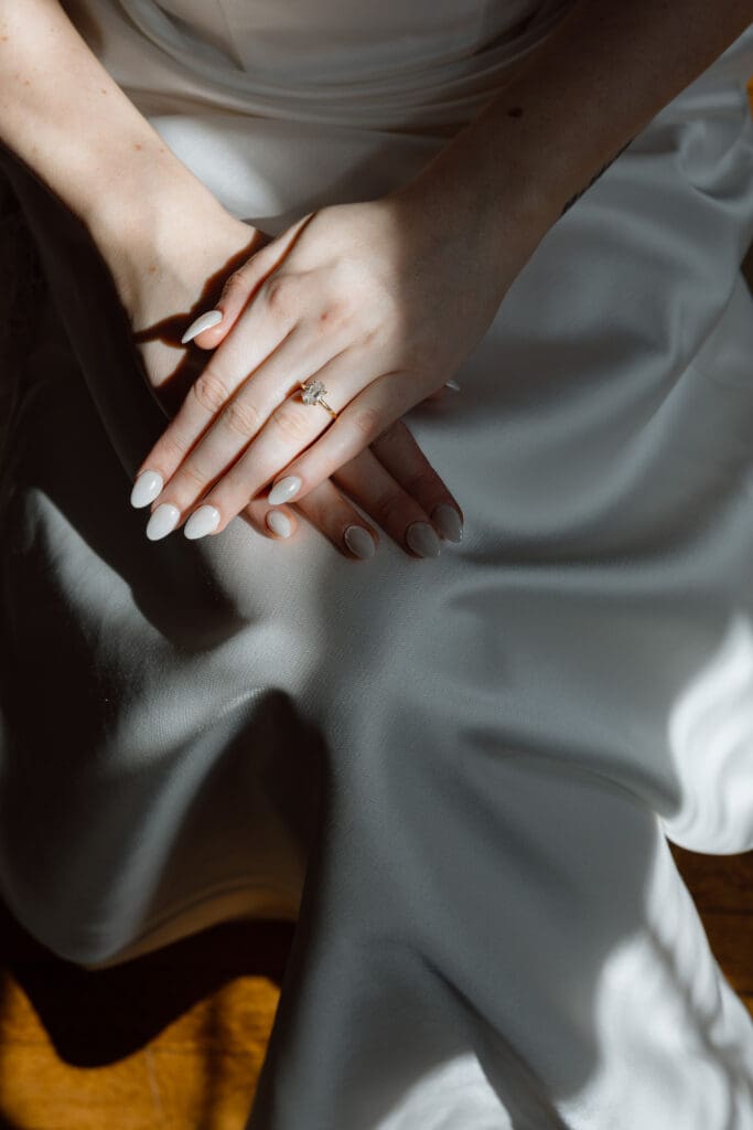 Bride showing her engagement ring while getting ready
