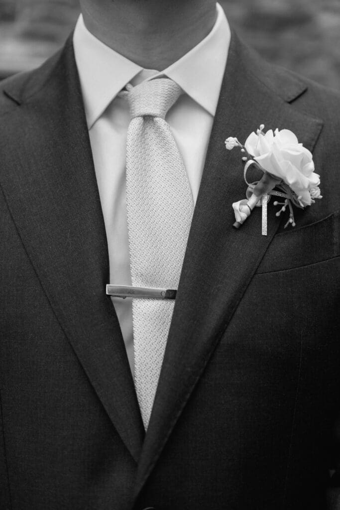 Groom suit and boutonniere detail on wedding day
