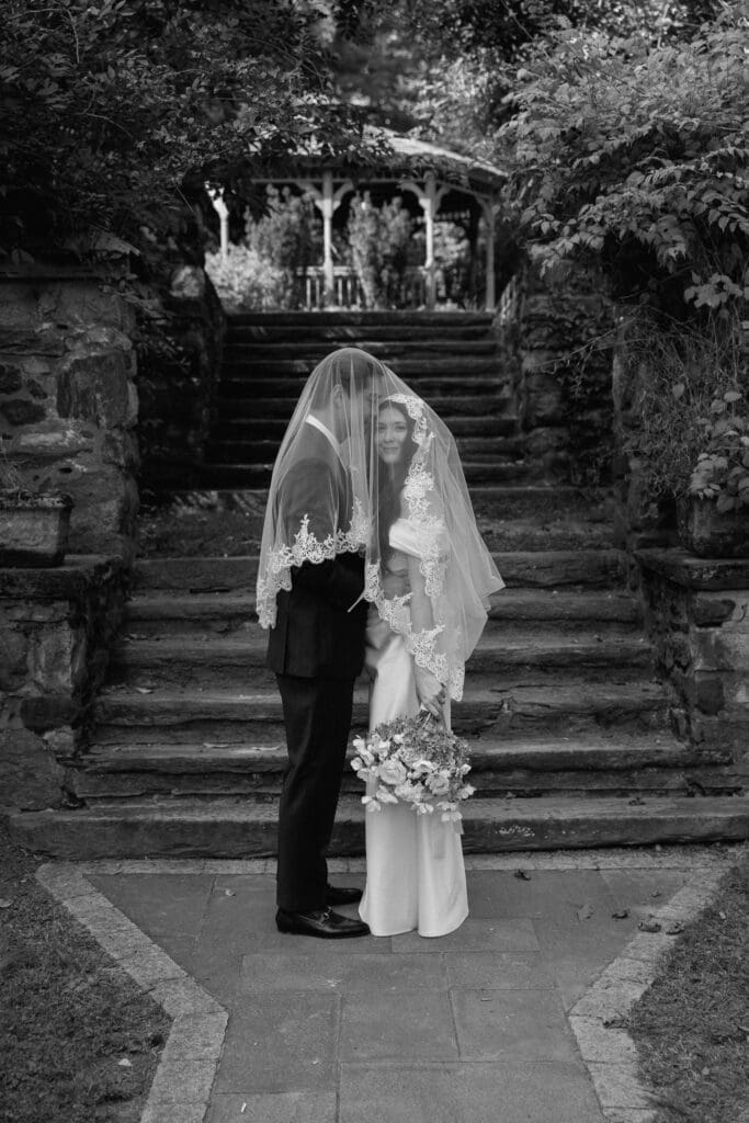 Black and white bride and groom portrait on the Parque garden steps
