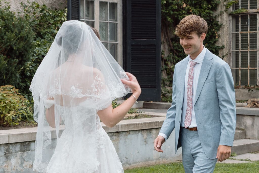 Groom smiling as he sees his bride during their first look
