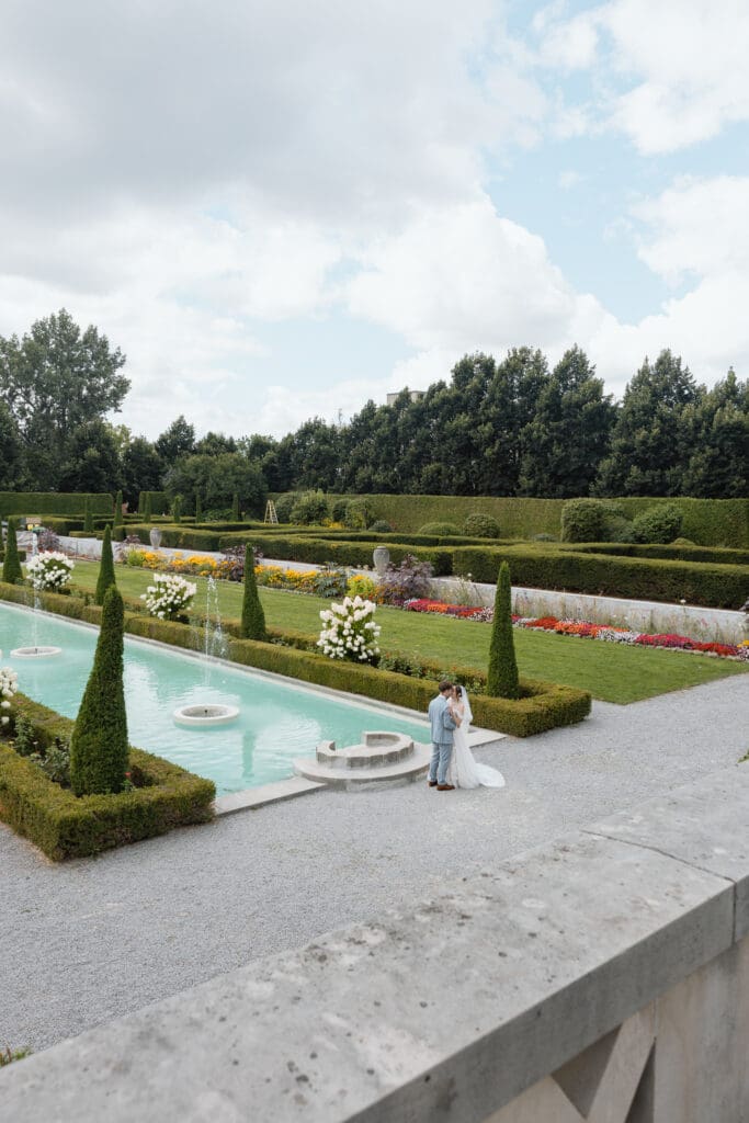 Bride and groom overlooking the formal gardens and reflecting pool at Parkwood Estate

